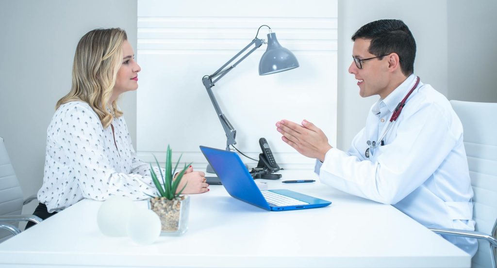 A woman talking to a doctor